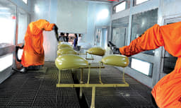 Programmable robots paint each part accurately. 